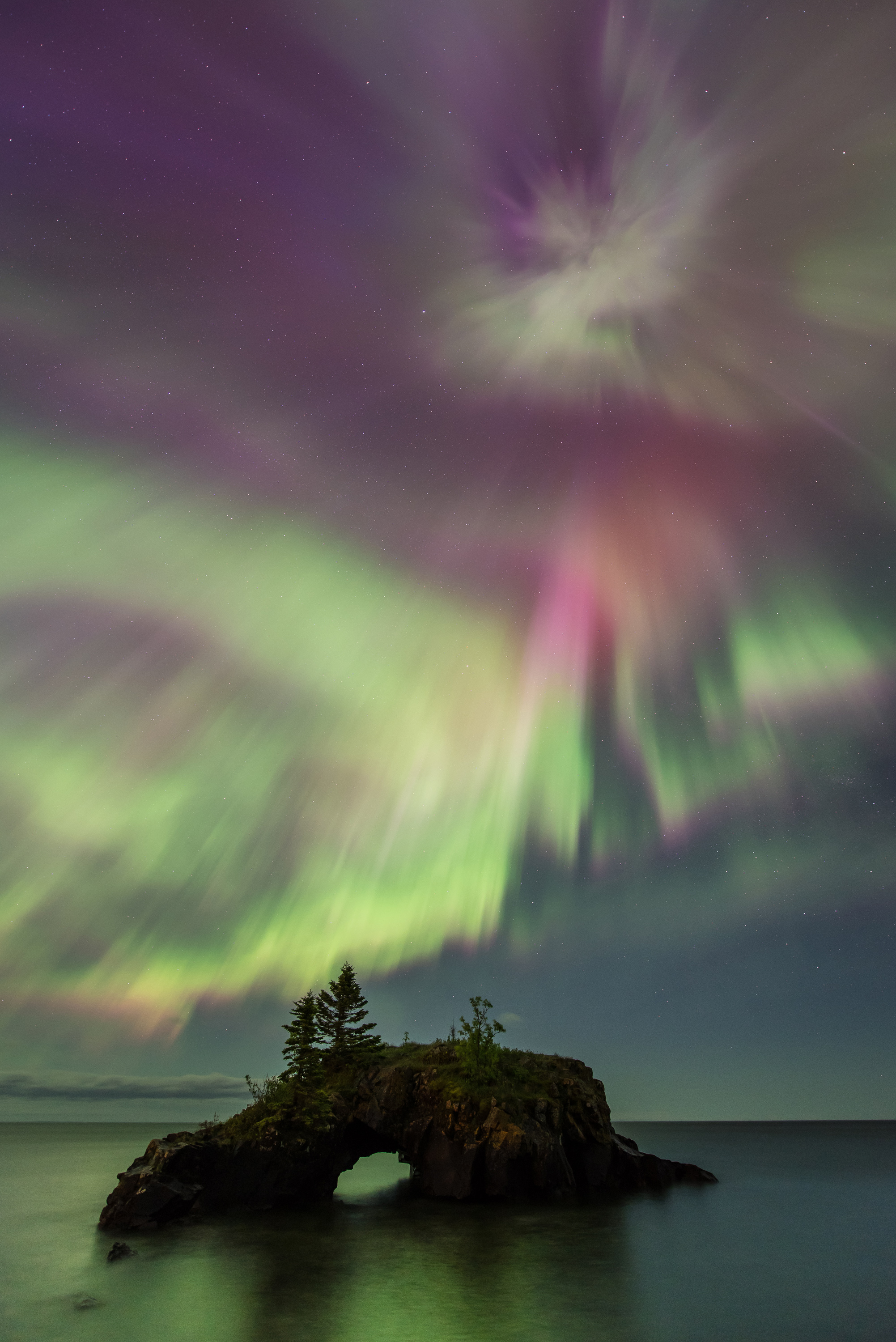 A couple watches the northern lights at Gooseberry Falls State Park