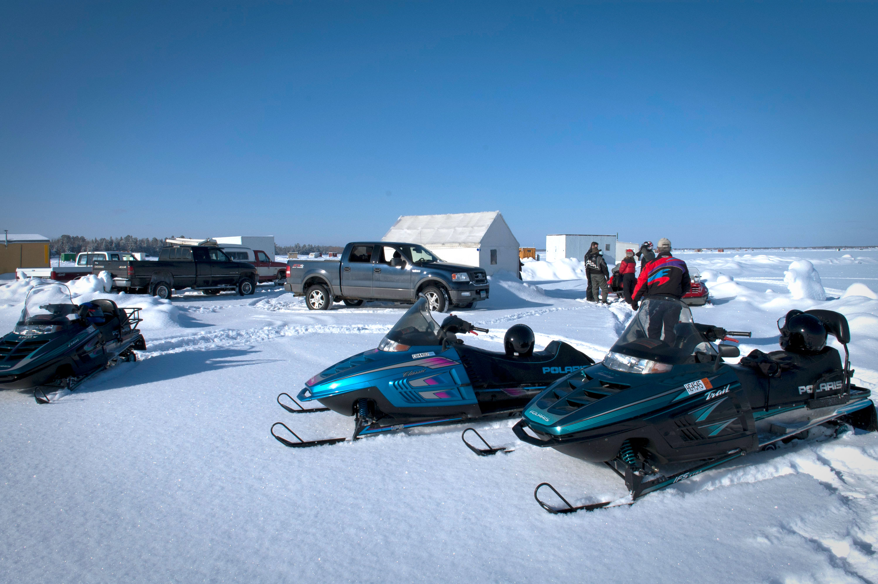 Ice fishing houses and snowmobiles on Rainy Lake