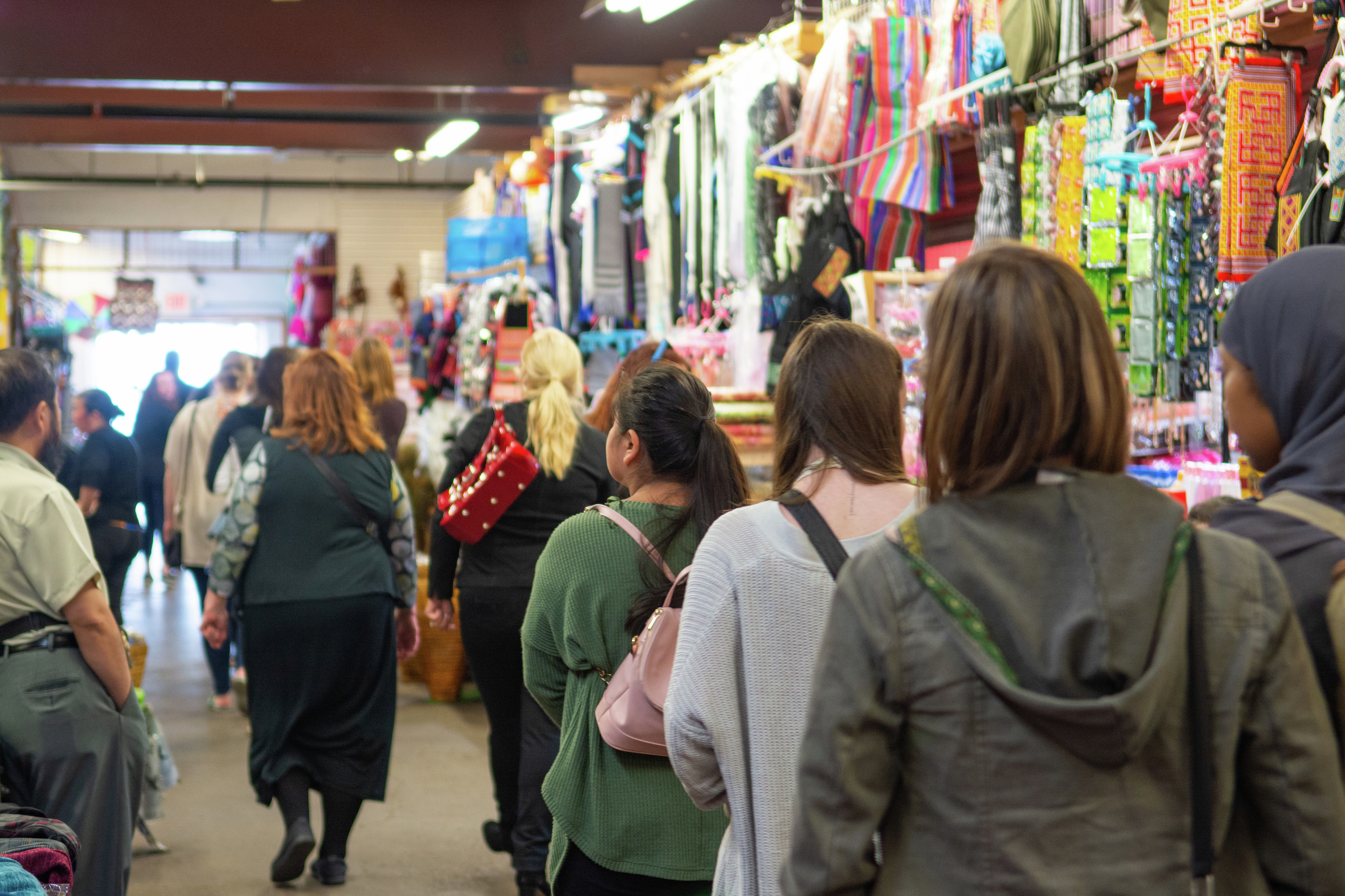 A crowd walks through Hmongtown Marketplace