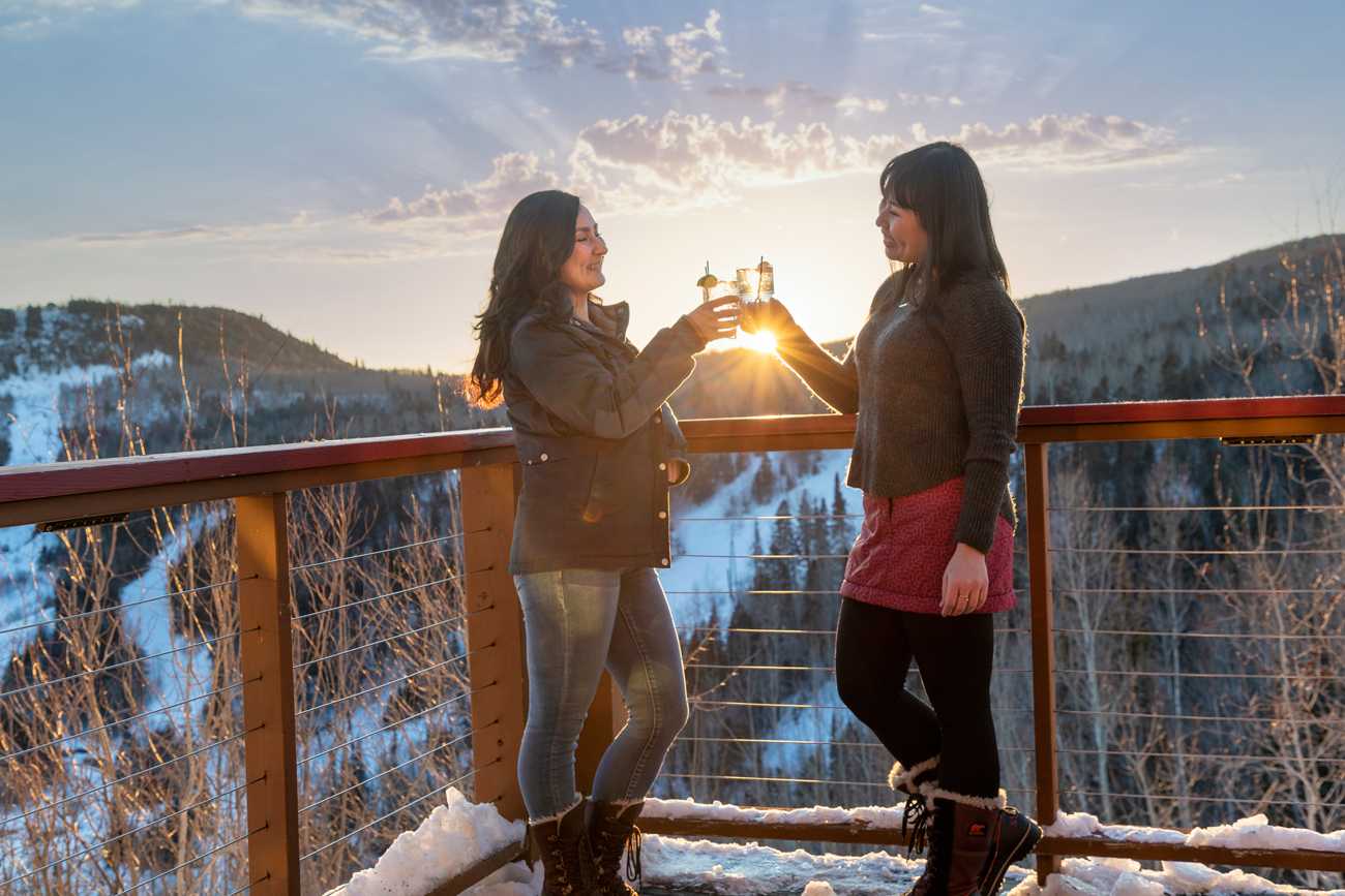 Girlfriends toast on the patio of Papa Charlie's overlooking Lutsen Mountain