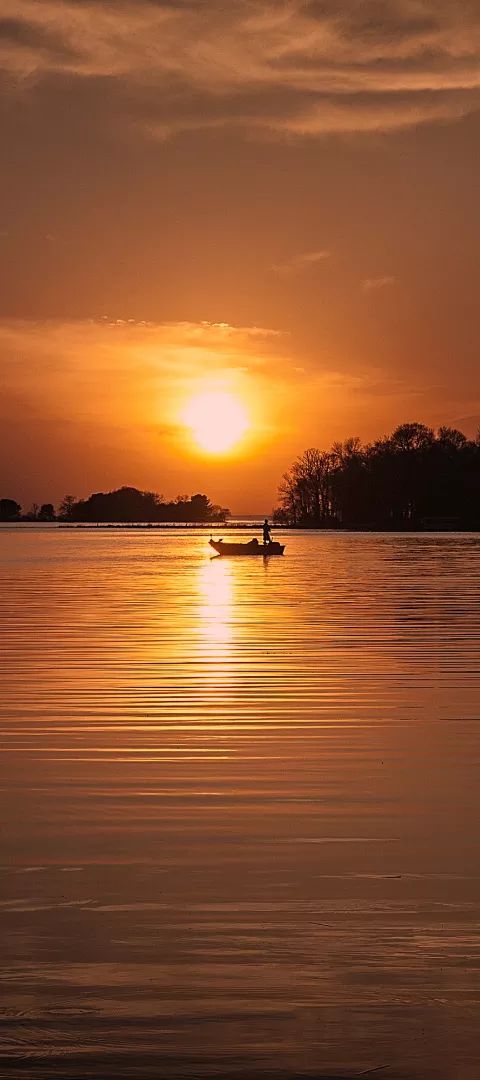 Sunset and a single boat on Lake Mille Lacs