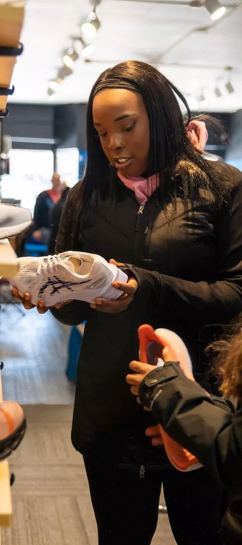 Two women shop for sneakers in Mankato's city center