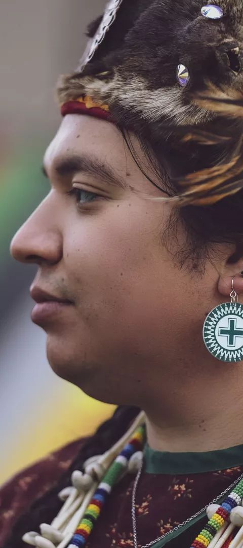 A model wears earrings by Četáŋ Ská designer Dyani White Hawk