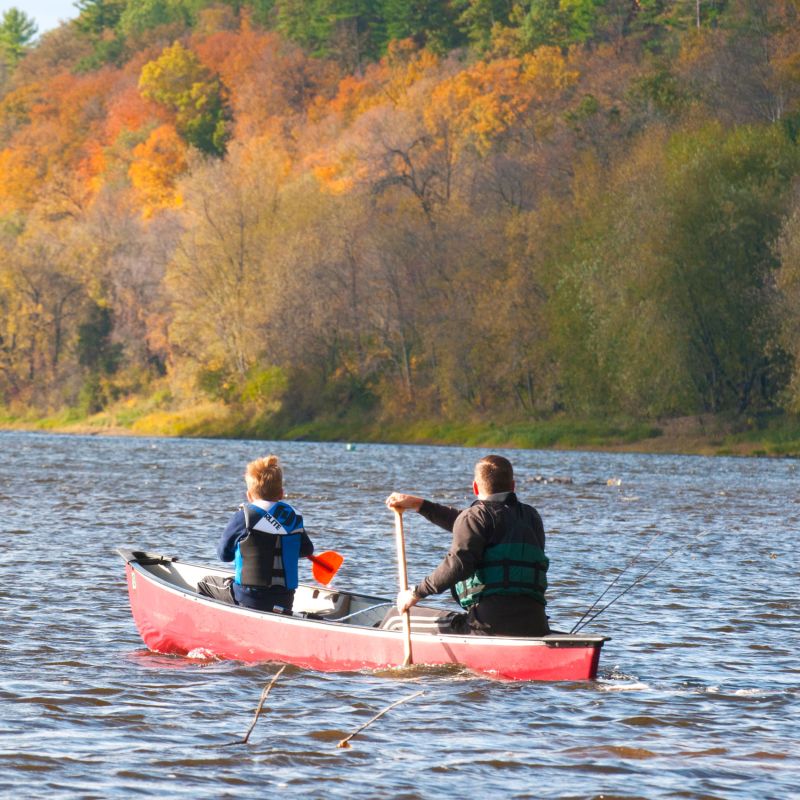 Father and son canoeing in the fall