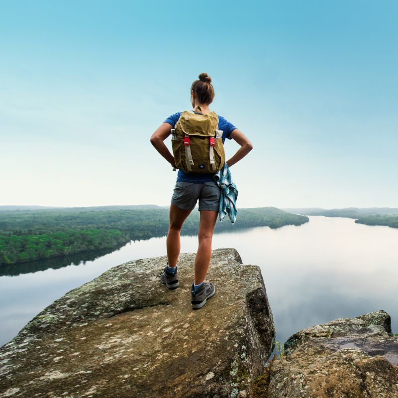 Female hiker at the top of Honeymoon Bluff in Grand Marais