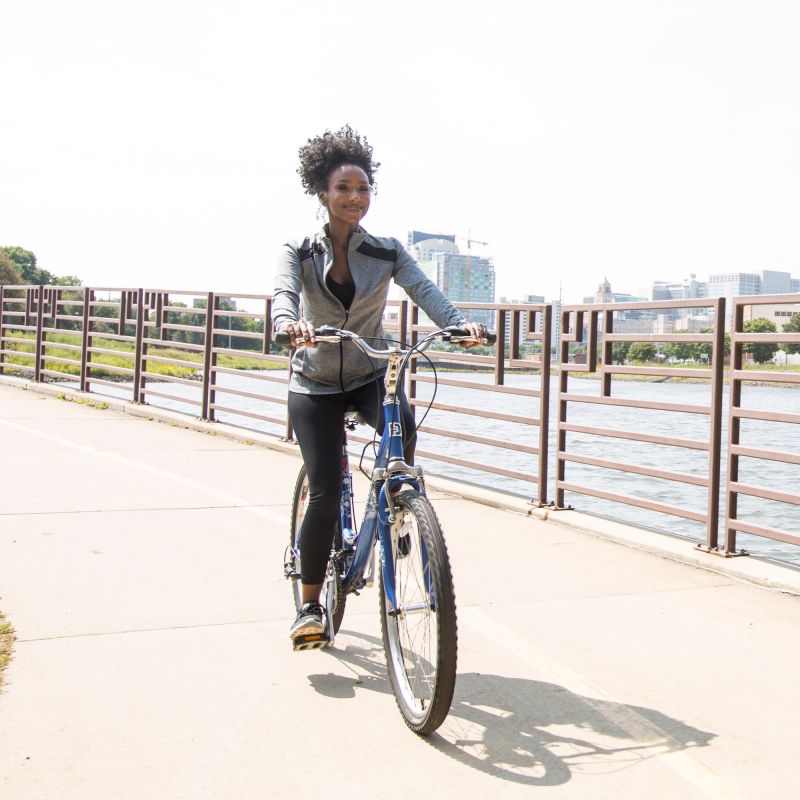 Woman biking around Silver Lake in Rochester