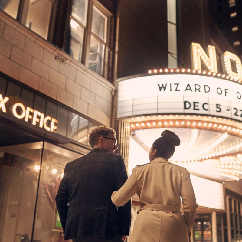 A couple walks up to the marquee outside Norshor Theatre